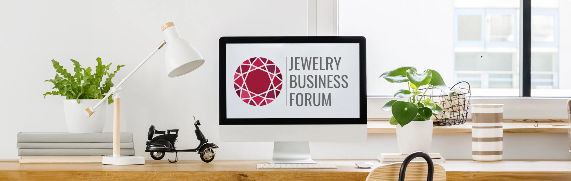 Jewelry Business Forum logo on laptop