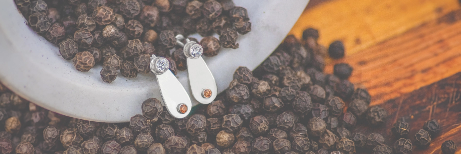 Pair of sterling silver earrings featuring light purple and orange gemstones