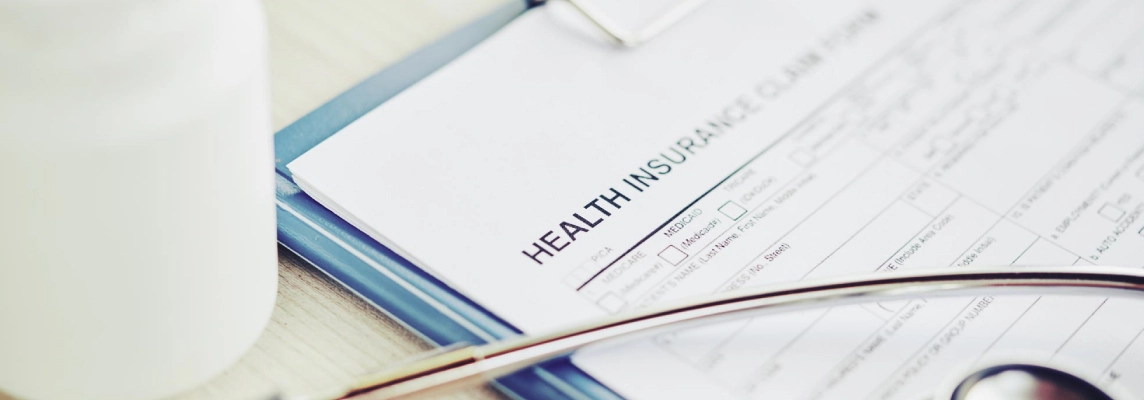 Health insurance forms on a clip board
