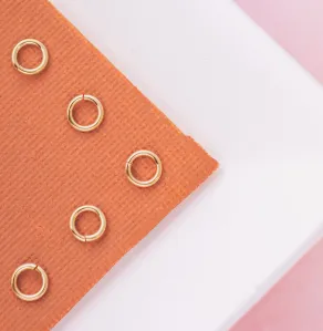 Gold-filled jump rings on an orange jewelry box