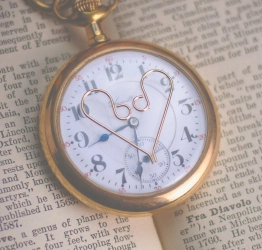 Gold-filled earwires laying on pocket watch