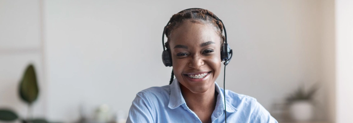 Young black woman with headset on smiling